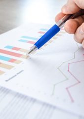 A pen pointing at a bar chart