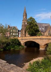 Image shows Telford Bridge in Morpeth on a suny day.